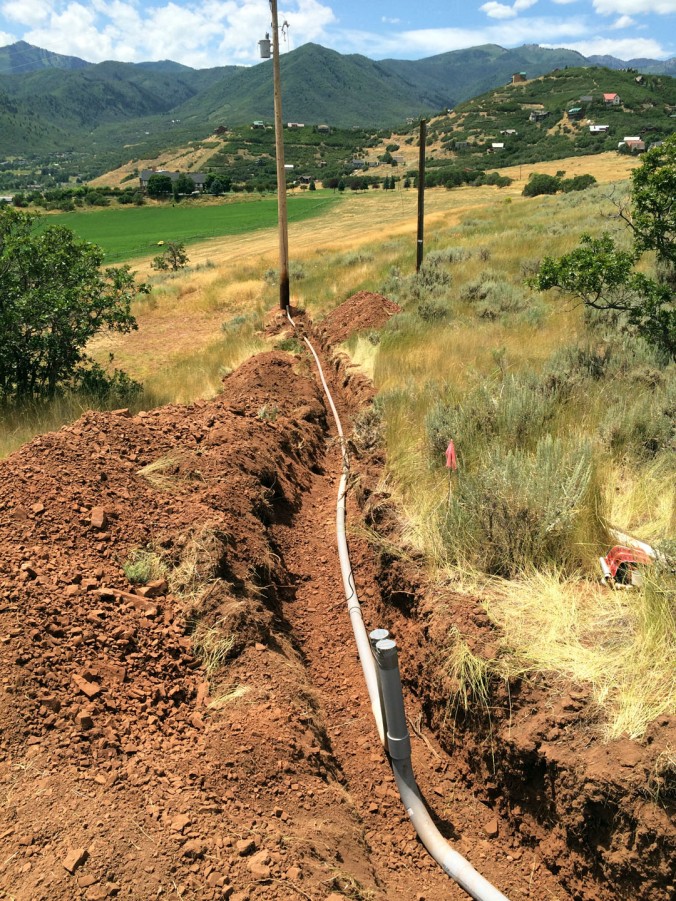 The power trench and conduit from a neighbors property to ours where a HUGE phone cable (holding about 50 wires) was cut several weeks ago and caused some big delays in getting power to the house.
