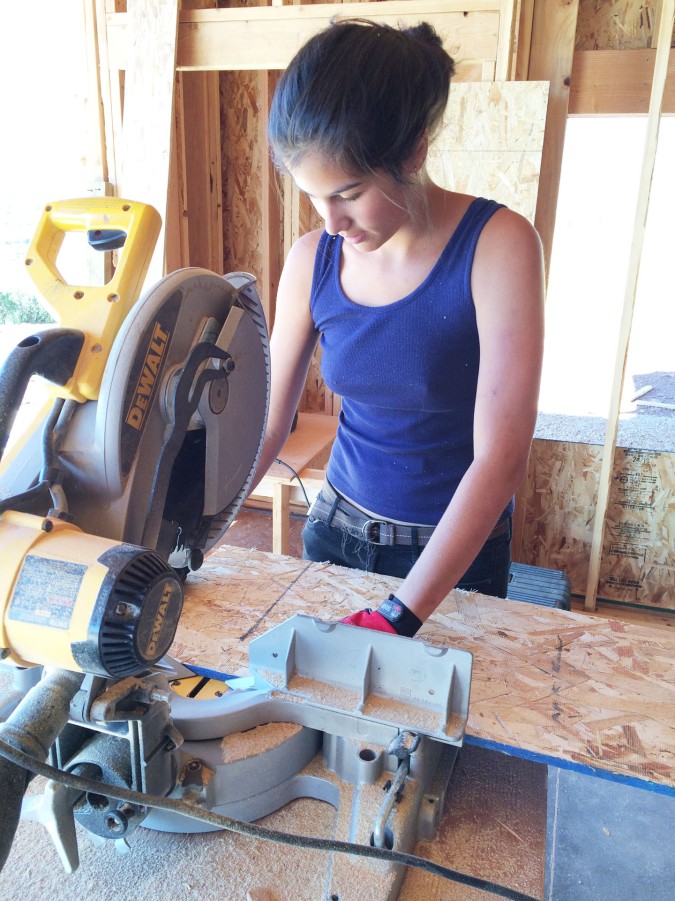 E cutting on the miter saw.