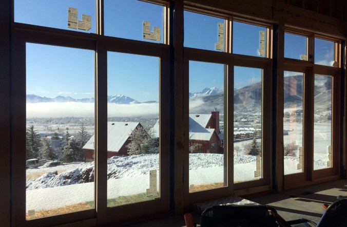 View from the great room of the valley enshrouded in fog and the mountains covered in snow.